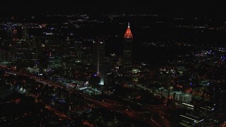 HD stock footage aerial video of flying by a tall skyscraper and city buildings at night, Midtown Atlanta, Georgia Aerial Stock Footage | CAP_013_013