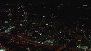 HD stock footage aerial video of passing by office buildings and skyscrapers at night, Midtown Atlanta, Georgia Aerial Stock Footage | CAP_013_015