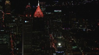 HD stock footage aerial video reverse view of Bank of America Plaza at night, Midtown Atlanta, Georgia Aerial Stock Footage | CAP_013_042