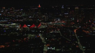 CAP_013_048 - HD stock footage aerial video of flying by the stadium near the downtown skyline at nighttime, Downtown Atlanta, Georgia