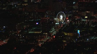 HD stock footage aerial video of a condo complex and Ferris wheel at nighttime, Downtown Atlanta, Georgia Aerial Stock Footage | CAP_013_058