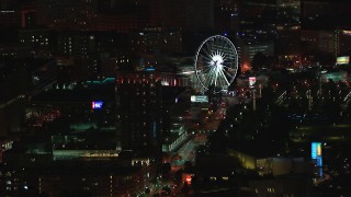 HD stock footage aerial video of flying by a condo complex and Ferris wheel at nighttime, Downtown Atlanta, Georgia Aerial Stock Footage | CAP_013_059