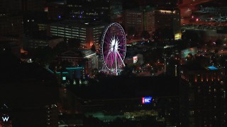 HD stock footage aerial video of flying by a Ferris wheel at nighttime, Downtown Atlanta, Georgia Aerial Stock Footage | CAP_013_061