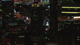 HD stock footage aerial video of passing by skyscrapers to reveal the Ferris wheel at night, Downtown Atlanta, Georgia Aerial Stock Footage | CAP_013_100