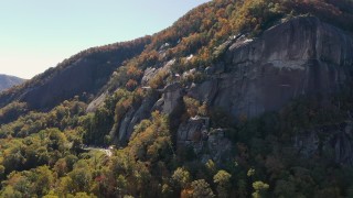 CAP_014_002 - 2.7K stock footage aerial video of orbiting a flag atop Chimney Rock in North Carolina