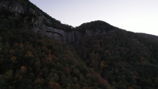 CAP_014_011 - 2.7K stock footage aerial video approach a waterfall at sunset, Chimney Rock, North Carolina