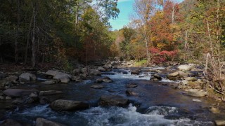 CAP_014_037 - 2.7K stock footage aerial video fly low over the river surrounded by forest trees, Chimney Rock, North Carolina