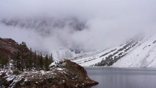 4K stock footage aerial video of flying low over the lake shore toward snowy mountain slopes, Inyo National Forest, California Aerial Stock Footage | CAP_015_006