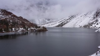 4K stock footage aerial video flying past snowy mountain slopes with view of Ellery Lake, Inyo National Forest, California Aerial Stock Footage | CAP_015_009