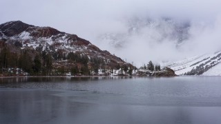 4K stock footage aerial video slowly approach lake shore and snowy mountain slopes, Inyo National Forest, California Aerial Stock Footage | CAP_015_015