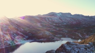 4K stock footage aerial video pan across snowy Sierra Nevada Mountains and lake at sunset, Inyo National Forest, California Aerial Stock Footage | CAP_015_030