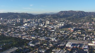 HD stock footage aerial video of a reverse view of Hollywood Sign and office buildings, California Aerial Stock Footage | CAP_016_027