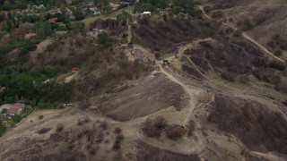 HD stock footage aerial video of flying above burned hills toward destroyed homes in Malibu, California Aerial Stock Footage | CAP_018_004