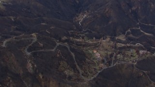 CAP_018_026 - HD stock footage aerial video reverse view of hillside homes destroyed by fire, Malibu, California