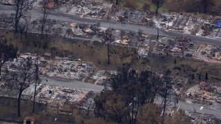 CAP_018_032 - HD stock footage aerial video of a close-up view of a neighborhood destroyed by fire, Malibu, California