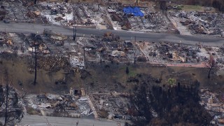 HD stock footage aerial video pan across homes in a neighborhood destroyed by fire, Malibu, California Aerial Stock Footage | CAP_018_033