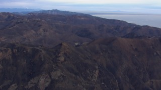 HD stock footage aerial video of approaching mountains scorched by fire, Malibu, California Aerial Stock Footage | CAP_018_040