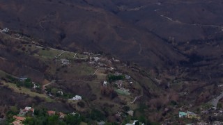 HD stock footage aerial video of mountains scorched by fire near, zoom in to fire-damaged homes, Malibu, California Aerial Stock Footage | CAP_018_043