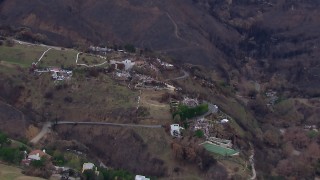 HD stock footage aerial video of flying toward homes destroyed by fire, Malibu, California Aerial Stock Footage | CAP_018_044