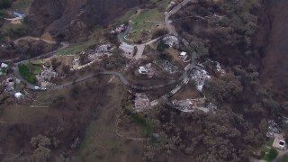 HD stock footage aerial video orbit and fly away from homes destroyed by fire, Malibu, California Aerial Stock Footage | CAP_018_047