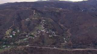 HD stock footage aerial video of a reverse view of homes destroyed by fire, Malibu, California Aerial Stock Footage | CAP_018_048