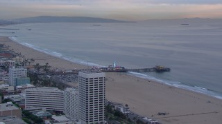 HD stock footage aerial video fly away from and orbit Santa Monica Pier at sunset, California Aerial Stock Footage | CAP_018_072