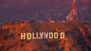 HD stock footage aerial video of flying away from the famous Hollywood Sign at sunset, California Aerial Stock Footage | CAP_018_085