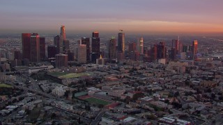 HD stock footage aerial video of flying by the Downtown Los Angeles skyline at sunset, California Aerial Stock Footage | CAP_018_089