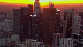 HD stock footage aerial video of flying by the Downtown Los Angeles skyscrapers at sunset, California Aerial Stock Footage | CAP_018_092