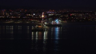 HD stock footage aerial video approach the Ferris wheel and rides at night, Santa Monica Pier, California Aerial Stock Footage | CAP_018_114