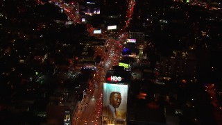 CAP_018_127 - HD stock footage aerial video fly over billboard for view of traffic on the Sunset Strip at night in West Hollywood, California