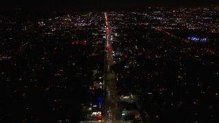 HD stock footage aerial video of tilting for a wide view of Sunset Blvd at night through Hollywood, California Aerial Stock Footage | CAP_018_135