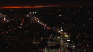 CAP_018_137 - HD stock footage aerial video approach Sunset Strip and tilt to billboards and traffic at night in West Hollywood, California