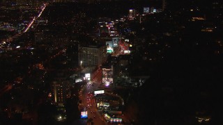 HD stock footage aerial video flying over Sunset Strip, billboards and traffic at night in West Hollywood, California Aerial Stock Footage | CAP_018_139