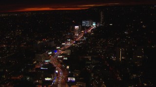 HD stock footage aerial video tilt for a view of Sunset Strip billboards and traffic at night in West Hollywood, California Aerial Stock Footage | CAP_018_142