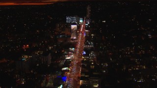 CAP_018_143 - HD stock footage aerial video approach Sunset Strip billboards and traffic at night in West Hollywood, California