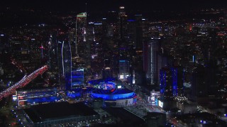 HD stock footage aerial video passing by Staples Center and the city's skyline at night, Downtown Los Angeles, California Aerial Stock Footage | CAP_018_185