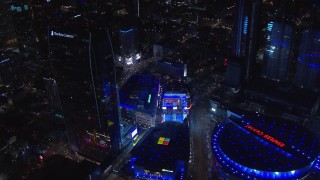 CAP_018_195 - HD stock footage aerial video orbit ice skating rink by theater and Ritz-Carlton at night, Downtown Los Angeles, California