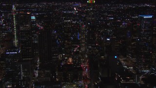 HD stock footage aerial video of orbiting tall skyscrapers at night, zoom closer to nearby high-rises, Downtown Los Angeles, California Aerial Stock Footage | CAP_018_211