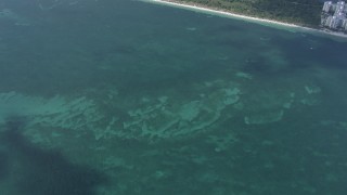 HD stock footage aerial video of a bird's eye view of the Atlantic Ocean, reveal shore of Key Biscayne near Miami, Florida Aerial Stock Footage | CAP_020_032