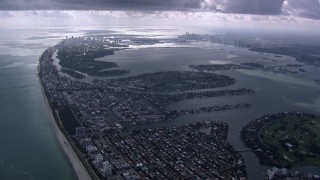 HD stock footage aerial video of flying over Miami Beach toward Biscayne Bay and Downtown Miami, Florida Aerial Stock Footage | CAP_020_059