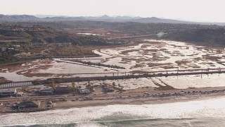 CAP_021_011 - HD stock footage aerial video passing by marshlands and coastal highway, Encinitas, California