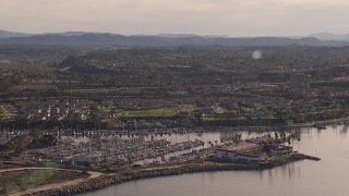 HD stock footage aerial video of a marina and oceanfront hotel by coastal neighborhood, Oceanside, California Aerial Stock Footage | CAP_021_027