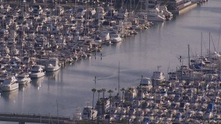 CAP_021_064 - HD stock footage aerial video orbit people paddling between yachts and sailboats at the harbor in Dana Point, California