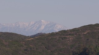 HD stock footage aerial video of a wide view of distant snowy mountains in Dana Point, California Aerial Stock Footage | CAP_021_066