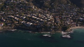 CAP_021_070 - HD stock footage aerial video flying by and away from oceanfront mansions in Laguna Beach, California