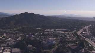 CAP_021_125 - HD stock footage aerial video of reverse view of Universal Studios Hollywood theme park, reveal downtown skyline, Universal City, California