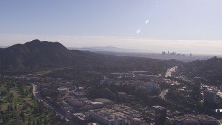 CAP_021_126 - HD stock footage aerial video of reverse view of Universal Studios Hollywood theme park, downtown skyline, Universal City, California