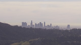 HD stock footage aerial video of the city's skyline on a hazy day, seen from Hollywood Hills, Downtown Los Angeles, California Aerial Stock Footage | CAP_021_129