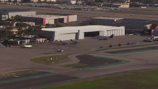 HD stock footage aerial video of civilian jets and helicopters at a Burbank Airport hangar, California Aerial Stock Footage | CAP_021_132